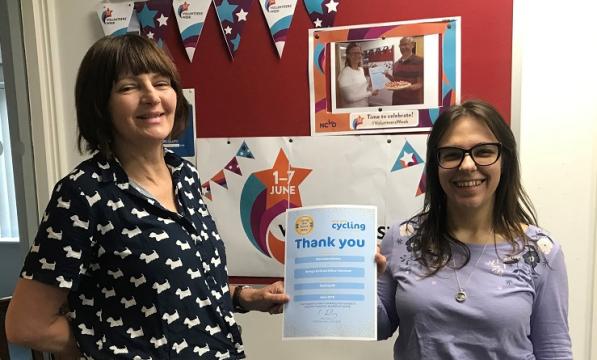 Julie presents office volunteer Stasi with her Thank You certificate