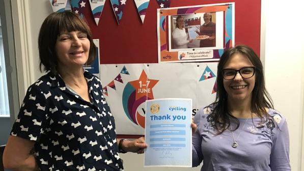 Julie presents office volunteer Stasi with her Thank You certificate