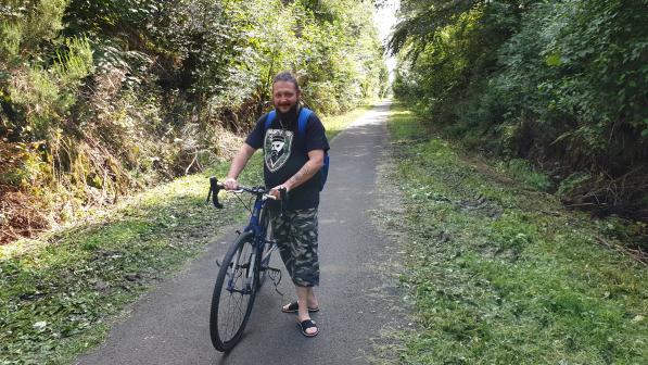 Chris McCann with his bike on a bicycle path