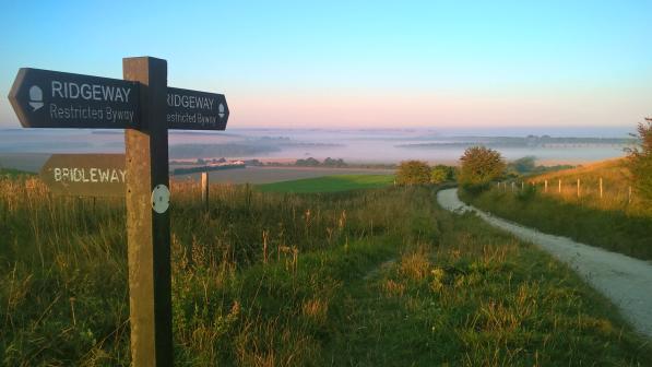 Finger post on the Ridgeway National Trail with hills in distance