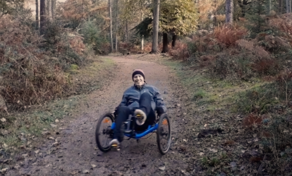 Rider on a trike in the forest.  