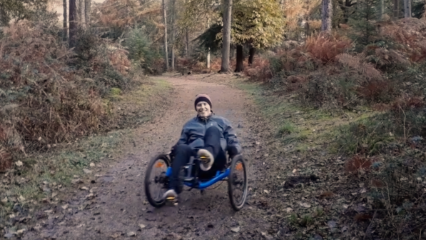 Rider on a trike in the forest.  