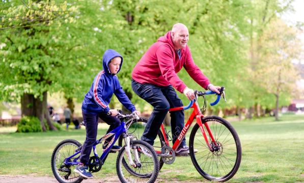 Father and son cycling together. Photo by Julie Skelton