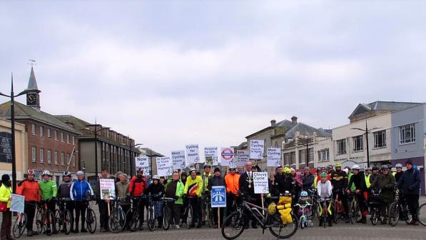 Group of cyclists holding placards