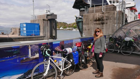 A touring cyclist waits for a ferry with their bike