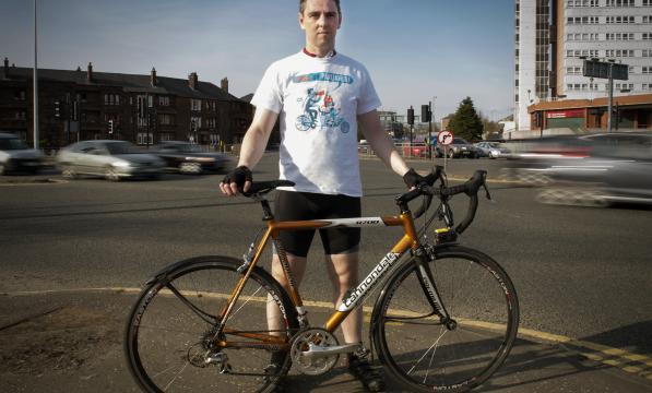 David Brennan standing with his bicycle