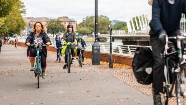 Cyclist ride along a wide path in central Cardiff