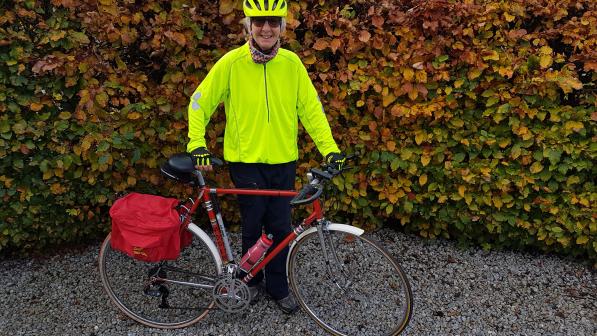 Woman standing with bike