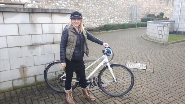 Woman standing with bike