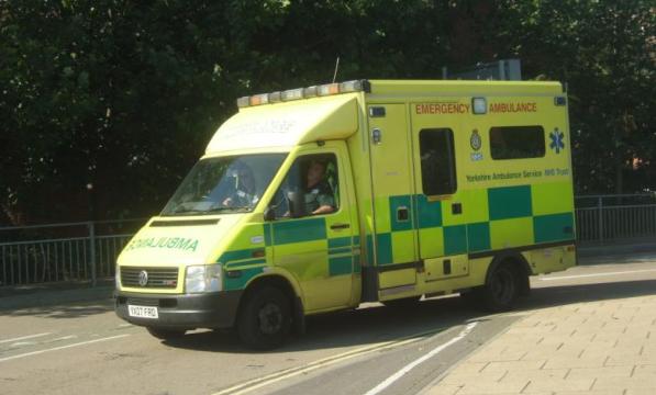Ambulance driving by a bike lane