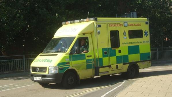 Ambulance driving by a bike lane