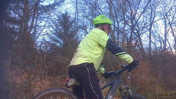 Man on e-bike facing away from camera