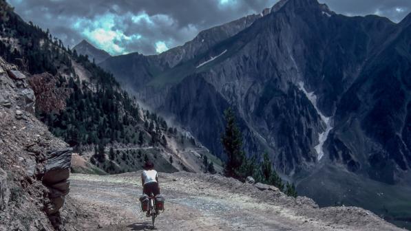 A cyclist heads towards an alpine landscape