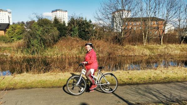 woman with bike on canal towpath
