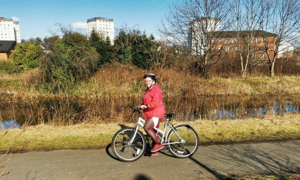 woman with bike on canal towpath
