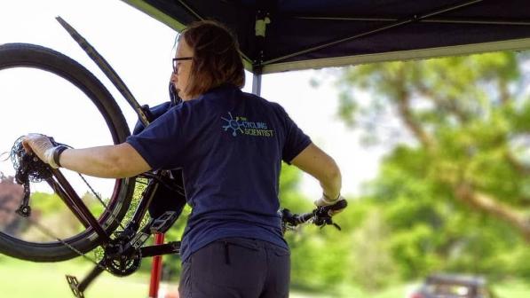 women working on bike which is on stand