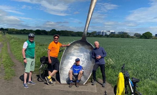 Group ride with giant spoon sculpture