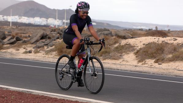 A woman cycles on a road bike