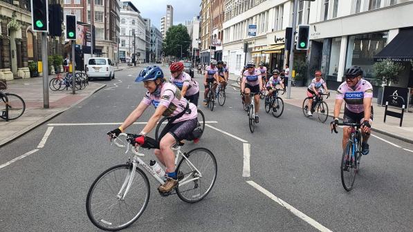 group of cyclists riding in London street