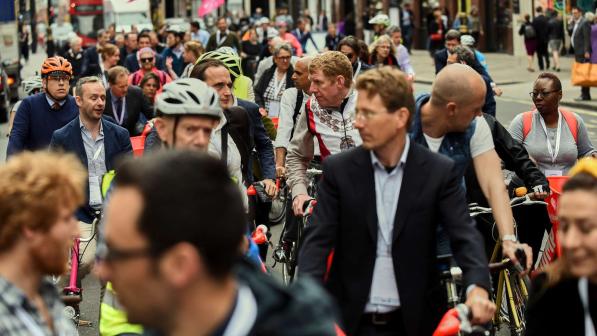A large group of cyclists in ordinary clothes waiting to start on a mass ride