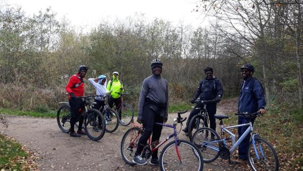 people standing with their bikes in the countryside