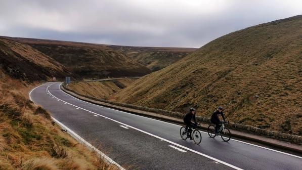 A pair of cyclists ride up the traffic free Snake Pass