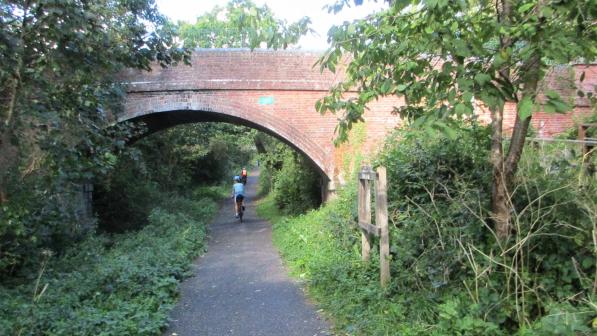 Riding under a bridge on the Cuckoo Trail