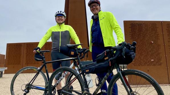 2 Cyclists by The Spire at the International Bomber Command Center