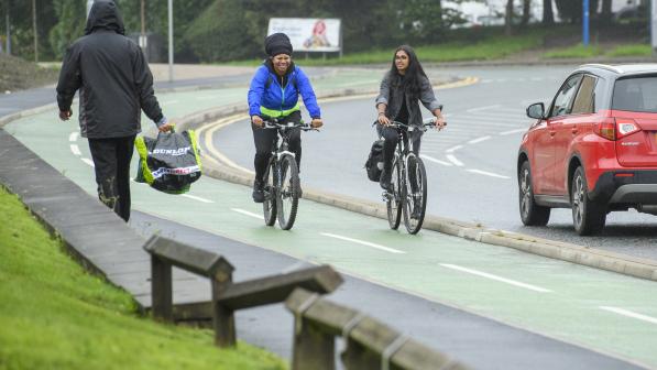 Two cyclists using segregated cycle lane in urban area