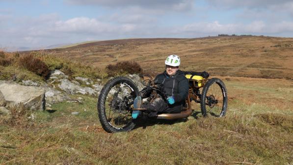 man on handcycle in off-road location in hills