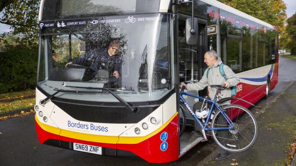 man boarding bus with bike