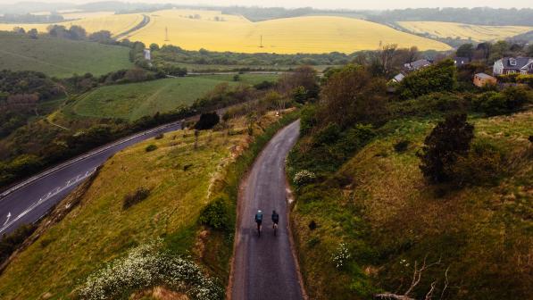 Drone shot of people cycling along a country lane in Kent