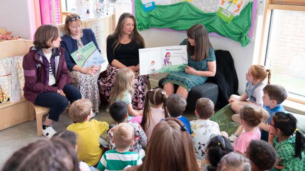 Scottish Minister for Children and Young People Clare Haughey reads a book about cycling to nursery children