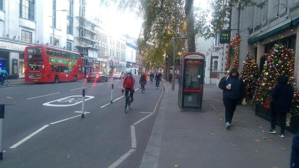 Cyclists make use of a segregated bike lane in London during Christmas time