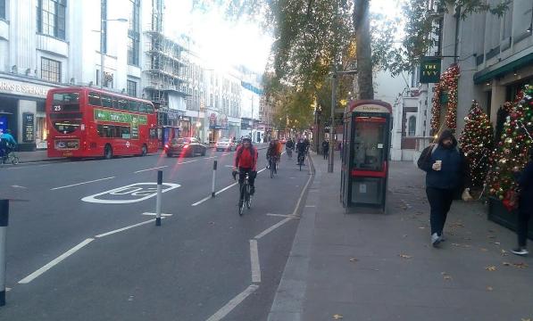 Cyclists make use of a segregated bike lane in London during Christmas time