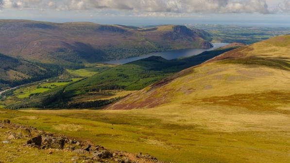 A view of rolling hills and a lake in a distance