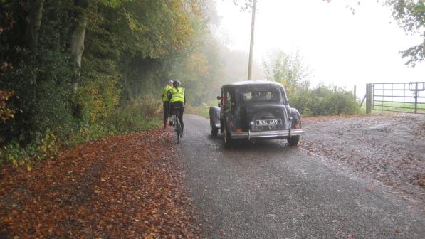 Veteran car and cyclists on a country lane