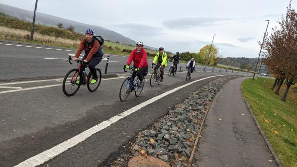 Five cyclists riding on a cycle path in Stirling