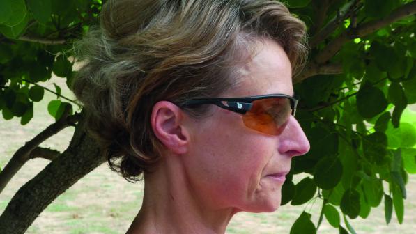 A woman's profile showcases a pair of sunglasses