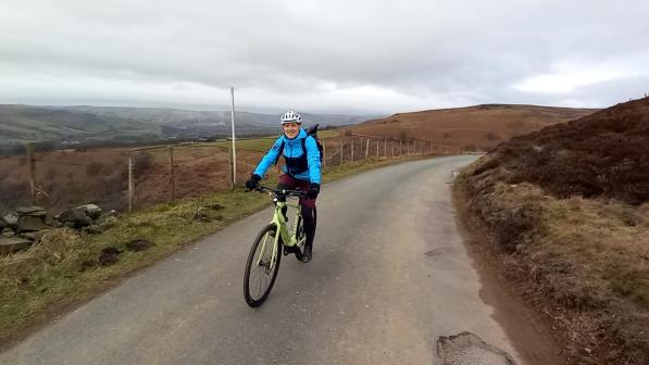 Simon ward smiles as he pedals a Making cycling e-asier e-cycle uphill