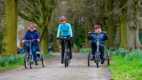 Dame Sarah Storey smiles as she pedals blue e-trike alongside participants through Debdale Park in Manchester on March 21 2023. Public event took place to mark the launch of Cycling UK's new e-cycle scheme, Making cycling e-asier, at Wheels for All.