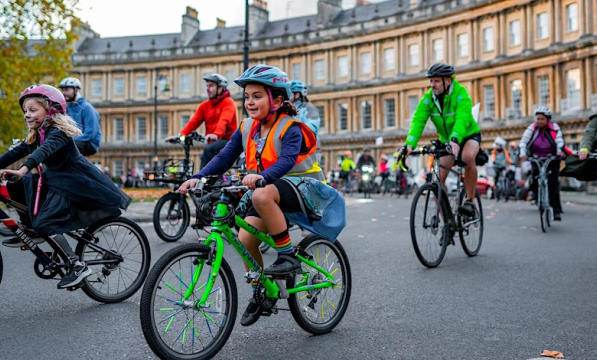 Children cycling around the Royal Crescent in Bath