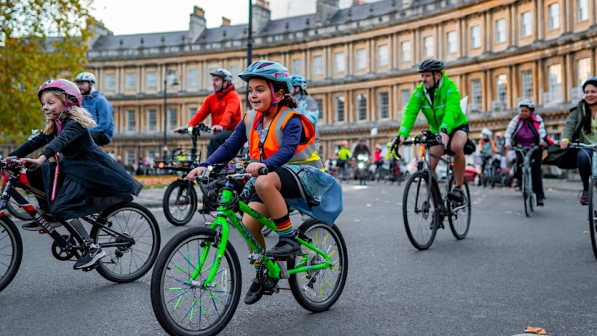 Children cycling around the Royal Crescent in Bath