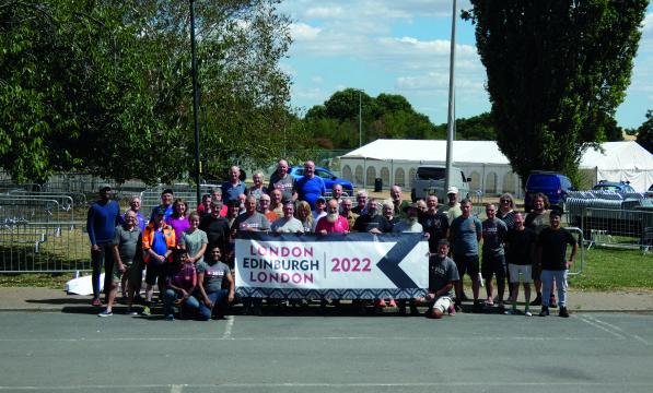 A large group of people stand behind a banner which reads London Edinburgh London 2022