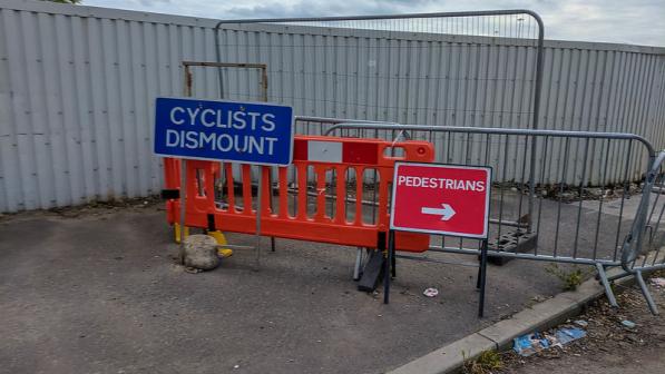 Cyclists Dismount sign cc JenOnTheMove