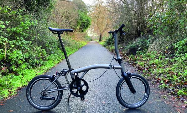 A foldable bicycle stands on a cycle path