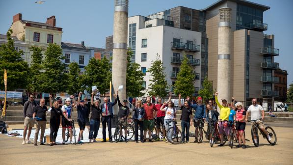 A big group of people standing in the Roald Dahl Plaza, along with assorted bikes