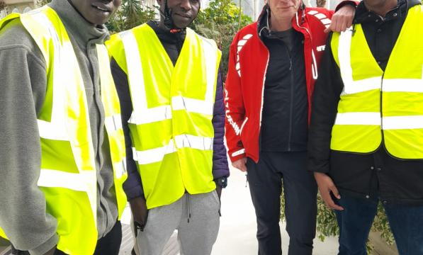 A group of four men in hi-viz jackets