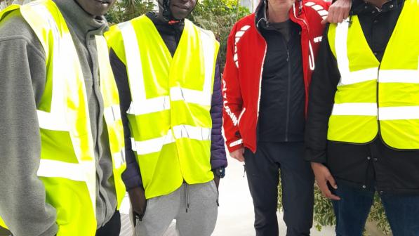 A group of four men in hi-viz jackets