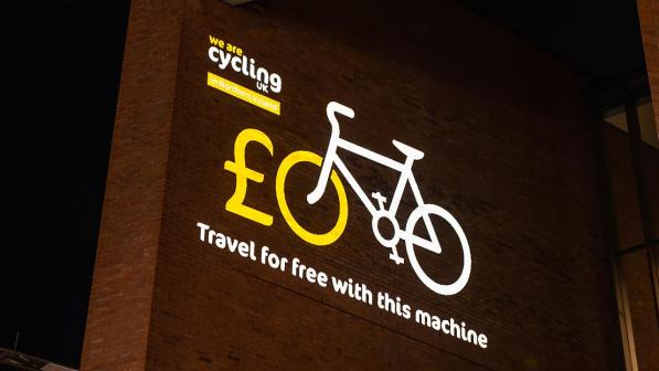 A projection of a cycle on the side of a building